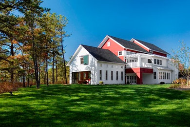 Large traditional red two-story mixed siding gable roof idea in Boston