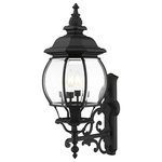 Livex Lighting - Textured Black Traditional, Colonial, French Historical, Outdoor Wall Lantern - The classically transitional outdoor Frontenac collection boasts a cast aluminum structure with dazzling ornamental design.  The upward facing four-light large six-sided wall lantern comes in a textured black finish with clear beveled glass and extravagantly decorative scrolls. The ornate quality of this light will add radiance to your house exterior day or night.