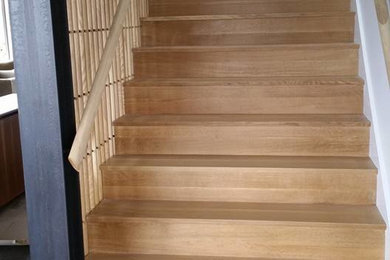 Inspiration for a modern wooden straight wood railing staircase remodel in Seattle with wooden risers