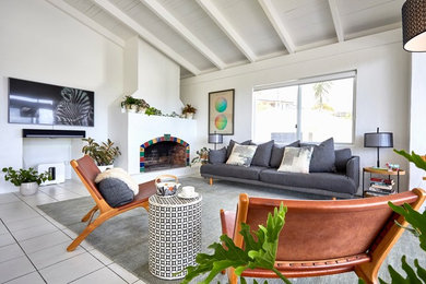 Large eclectic open concept living room in Other with white walls, ceramic floors, a standard fireplace, a concrete fireplace surround, a wall-mounted tv and white floor.