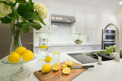 Kitchen pantry - small transitional single-wall dark wood floor and brown floor kitchen pantry idea in New York with an undermount sink, flat-panel cabinets, white cabinets, quartz countertops, white backsplash, stone slab backsplash, stainless steel appliances, an island and white countertops