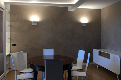 Ispirazione per una sala da pranzo aperta verso il soggiorno moderna con pareti marroni e pavimento in legno massello medio