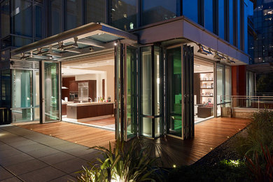 Large trendy courtyard concrete paver patio photo in Vancouver with a fire pit and no cover