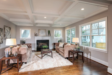 This is an example of a mid-sized arts and crafts formal enclosed living room in DC Metro with grey walls, medium hardwood floors, a standard fireplace, a stone fireplace surround and no tv.