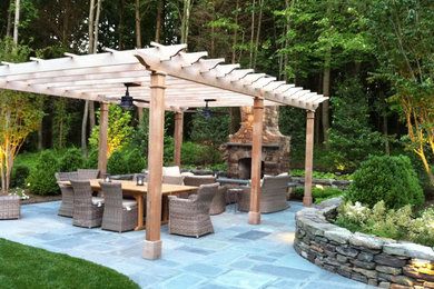 Large elegant backyard concrete paver patio photo in DC Metro with a fire pit and a pergola