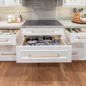 Cooktop and base cabinetry with open drawers