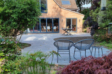 Inspiration for a medium sized traditional patio in Dorset with tiled flooring.