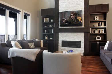 Inspiration for a mid-sized timeless open concept medium tone wood floor living room remodel in Calgary with beige walls, a standard fireplace, a stone fireplace and a wall-mounted tv