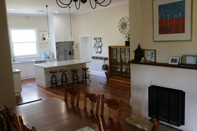 AFTER - open area complete with new jarrah flooring and fireplace
