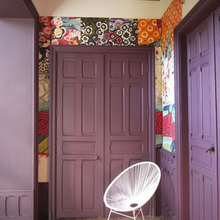 Inspiration for an expansive eclectic foyer in Angers with purple walls, light hardwood floors, a single front door, a medium wood front door and beige floor.