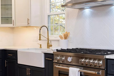 Example of a l-shaped light wood floor eat-in kitchen design in Baltimore with a farmhouse sink, shaker cabinets, quartz countertops, white backsplash, subway tile backsplash and stainless steel appliances
