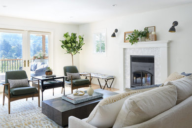 Mid-sized transitional open concept living room in San Francisco with white walls, medium hardwood floors, a standard fireplace, a metal fireplace surround and no tv.