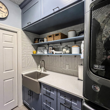 Laundry Room with Blue Painted Cabinetry and Sparkling White Quartz Countertops
