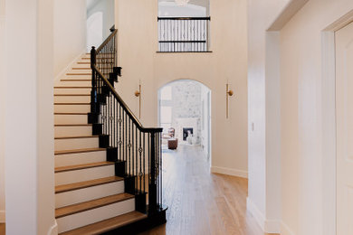 Large french country light wood floor, brown floor and tray ceiling foyer photo in Austin with white walls