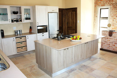 Inspiration for a mid-sized rustic open concept kitchen remodel in Other with a double-bowl sink, shaker cabinets, light wood cabinets, granite countertops, stainless steel appliances and an island