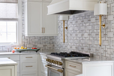 Open concept kitchen - mid-sized transitional l-shaped open concept kitchen idea in Charlotte with a drop-in sink, recessed-panel cabinets, white cabinets, quartz countertops, white backsplash, marble backsplash, stainless steel appliances, an island and white countertops