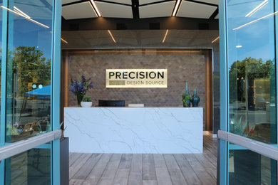 Example of a small transitional galley light wood floor and gray floor home bar design in San Francisco with recessed-panel cabinets, gray cabinets, quartz countertops and white countertops