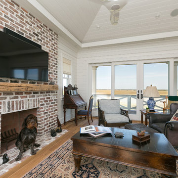 Living Room with V-groove wood vaulted ceiling and brick fireplace