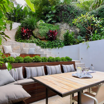 Tiered Outdoor Living Layout with Built-In Fire Pit and Dining Terrace
