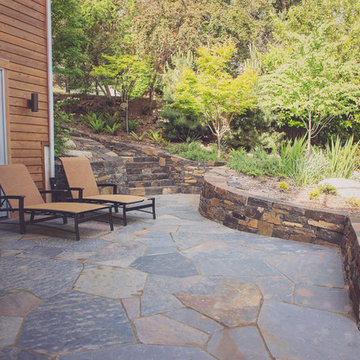 Ledgestone staircase with stacked basalt retaining walls and flagstone patio