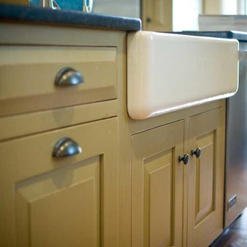 Deep, porcelain farm sink, installed below counter edge for easy cleanup.