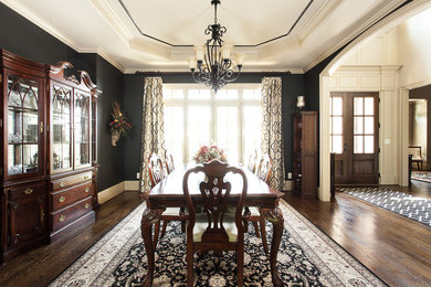Mid-sized traditional open plan dining in Atlanta with black walls, dark hardwood floors and no fireplace.