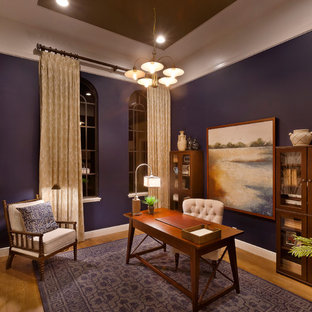 This is an example of a mid-sized country study room in Tampa with medium hardwood floors, a freestanding desk and purple walls.