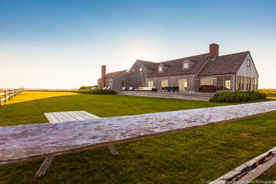 Large coastal brown two-story wood gable roof idea in Boston