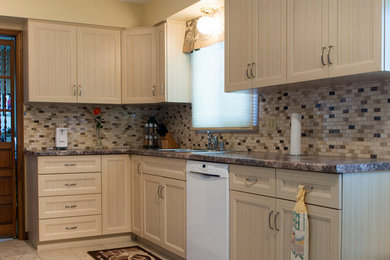 Transitional u-shaped kitchen in Toronto with recessed-panel cabinets, light wood cabinets, granite benchtops, multi-coloured splashback, mosaic tile splashback, white appliances, no island and beige floor.