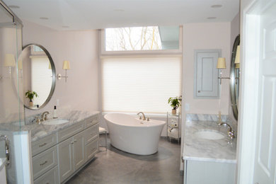 Inspiration for a mid-sized timeless master white tile and porcelain tile porcelain tile, gray floor and double-sink bathroom remodel in Cleveland with shaker cabinets, gray cabinets, a two-piece toilet, beige walls, an undermount sink, marble countertops, a hinged shower door, gray countertops and a built-in vanity