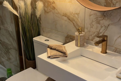 Single Corian hidden waste vanity with towel Corian shelf