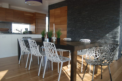 Example of a mid-sized trendy light wood floor kitchen/dining room combo design in Boston with white walls and no fireplace