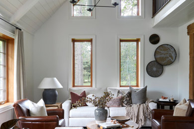 Mid-sized transitional loft-style medium tone wood floor, brown floor, vaulted ceiling and shiplap wall living room photo in Toronto with white walls