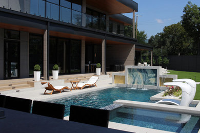 Example of a large minimalist backyard rectangular lap pool design in Dallas with decking
