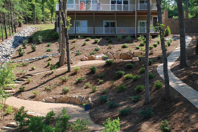 Design ideas for a large traditional partial sun hillside concrete paver landscaping in Other.