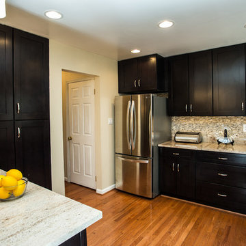 Espresso Kitchen Remodel with Granite Island and Stainless Steel Appliances