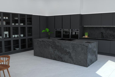 Photo of a large modern grey and black kitchen/diner in Dorset with a built-in sink, flat-panel cabinets, black cabinets, black splashback, ceramic splashback, black appliances, porcelain flooring, an island, white floors, black worktops, a vaulted ceiling and feature lighting.