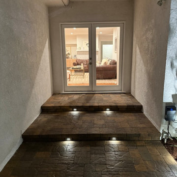 Warmly Lit Entryway with Stone Steps & Modern Doors