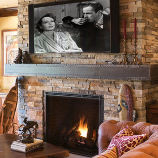 World-inspired walk-out basement in Minneapolis with yellow walls, dark hardwood flooring, a standard fireplace and a stone fireplace surround.