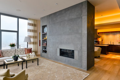 Contemporary open concept living room in Portland with medium hardwood floors, a ribbon fireplace and a concrete fireplace surround.