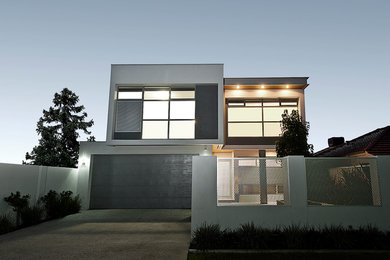 Modern two-storey white house exterior in Perth with mixed siding, a flat roof and a metal roof.