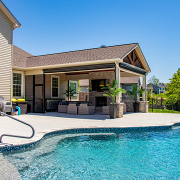 Pool-Side Outdoor Room with a Fireplace and Sitting Walls
