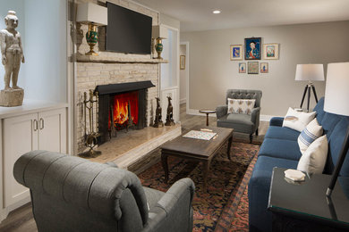 Mid-sized transitional enclosed medium tone wood floor and brown floor living room photo in Austin with beige walls, a standard fireplace and a stone fireplace