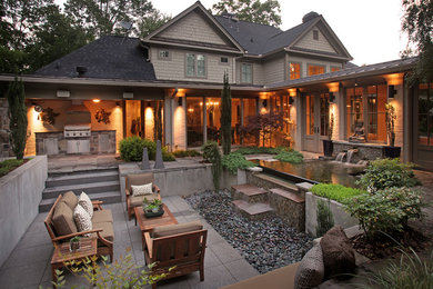 Photo of a large country backyard patio in Atlanta with a water feature, natural stone pavers and a pergola.