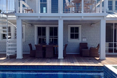Example of a large beach style gray two-story wood exterior home design in Other with a metal roof