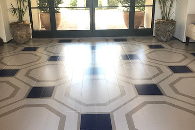 Mid-sized trendy beige floor entryway photo in San Diego with white walls and a medium wood front door
