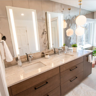 Inspiration for a contemporary bathroom in Cincinnati with medium wood cabinets, mirror tile, granite benchtops, beige benchtops, a double vanity and a built-in vanity.