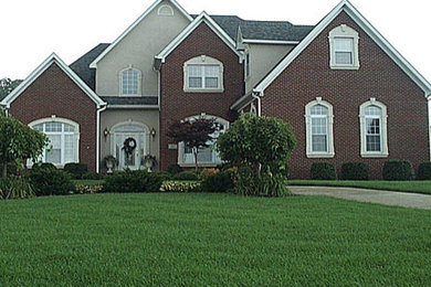 Example of a mid-sized classic multicolored two-story brick gable roof design in San Diego