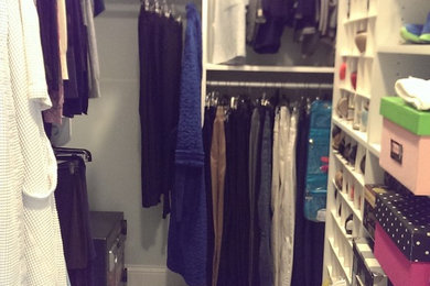 Inspiration for a large gender-neutral walk-in closet remodel in Louisville with open cabinets and white cabinets