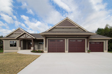 Mid-sized transitional one-storey grey exterior in Milwaukee with wood siding and a gable roof.